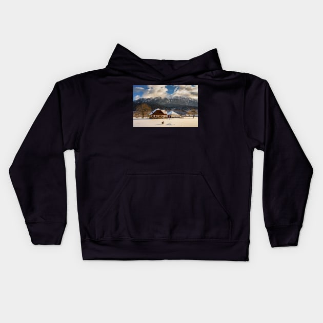 House by the mountains, winter time Kids Hoodie by naturalis